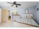 Bright bedroom with a wooden bed frame, neutral decor, and a ceiling fan at 142 Ethan Ave, Davenport, FL 33897