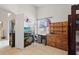 This bedroom features neutral tile flooring, a wooden dresser, and a desk at 142 Ethan Ave, Davenport, FL 33897