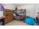 This bedroom features a bunk bed, wood dresser, and blue beanbag chair at 142 Ethan Ave, Davenport, FL 33897