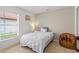 Cozy bedroom with tiled floors and a comfy brown beanbag chair at 142 Ethan Ave, Davenport, FL 33897
