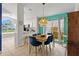 Bright dining room with unique light fixture, seating for six, and views of the exterior at 142 Ethan Ave, Davenport, FL 33897