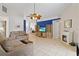 Spacious living room featuring tile flooring, a fireplace, and a blue accent wall at 142 Ethan Ave, Davenport, FL 33897