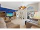 Spacious living room with fireplace, ceiling fan, and pool view at 142 Ethan Ave, Davenport, FL 33897