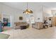 Bright and open living area features neutral colors, tile floors, and access to other rooms at 142 Ethan Ave, Davenport, FL 33897