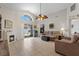Spacious living room with tiled floors, a fireplace, and views of the pool through sliding glass doors at 142 Ethan Ave, Davenport, FL 33897
