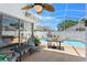 Relaxing outdoor patio with view of private in-ground swimming pool and screened enclosure at 142 Ethan Ave, Davenport, FL 33897