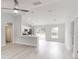 Bright open-concept living area with modern flooring and a view into the kitchen at 14512 Sw 25Th Lane, Ocala, FL 34481