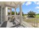 Balcony view overlooking golf course with white railings, columns, and shade at 1501 Northern Harrier Way # 202, Reunion, FL 34747