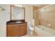 Bathroom featuring wood vanity with black countertop and a tub-shower combo at 1501 Northern Harrier Way # 202, Reunion, FL 34747