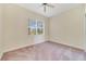 Bedroom with plush carpeting and large window with blinds at 1501 Northern Harrier Way # 202, Reunion, FL 34747