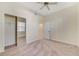 A comfortable bedroom with neutral tones, ceiling fan, closet, and an en-suite bathroom at 1501 Northern Harrier Way # 202, Reunion, FL 34747