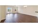Spacious living room with hardwood floors, ceiling fan, and French doors at 1501 Northern Harrier Way # 202, Reunion, FL 34747