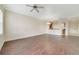 Spacious living room with hardwood flooring and a ceiling fan at 1501 Northern Harrier Way # 202, Reunion, FL 34747
