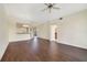 Open living room with hardwood floors and a view to the kitchen area at 1501 Northern Harrier Way # 202, Reunion, FL 34747