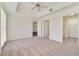 Spacious main bedroom featuring ceiling fan, closet, and multiple doorways at 1501 Northern Harrier Way # 202, Reunion, FL 34747