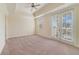 Spacious main bedroom with tray ceiling, ceiling fan, and balcony access at 1501 Northern Harrier Way # 202, Reunion, FL 34747