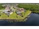 An aerial view showcasing the lakeside homes with screened patios at 15037 Cedar Branch Way, Orlando, FL 32824