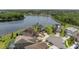 Aerial view of homes in a lakeside community with lush landscaping and cul-de-sac streets at 15037 Cedar Branch Way, Orlando, FL 32824