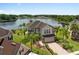 An aerial view of a two story home next to a calm lake at 15037 Cedar Branch Way, Orlando, FL 32824