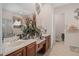 Bathroom offers double sinks, large mirror, decorative accents, and tiled floors at 15037 Cedar Branch Way, Orlando, FL 32824