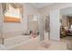 Primary bathroom with jetted tub, glass enclosed shower, and natural light at 15037 Cedar Branch Way, Orlando, FL 32824