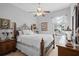 Comfortable bedroom features ornate wooden furniture, a ceiling fan, and a bright window at 15037 Cedar Branch Way, Orlando, FL 32824
