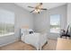 Bright bedroom with a cozy bed, ample natural light, a ceiling fan, and serene views from the window at 15037 Cedar Branch Way, Orlando, FL 32824