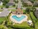 Aerial view of a community pool with lounge chairs and shaded seating areas at 15037 Cedar Branch Way, Orlando, FL 32824