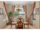 Cozy dining area with a glass top table, comfortable chairs, and natural light at 15037 Cedar Branch Way, Orlando, FL 32824