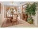 Sunlit dining area with traditional furniture, large windows and elegant decor at 15037 Cedar Branch Way, Orlando, FL 32824