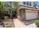 Beautiful two-story home with stone accents, a well-manicured lawn, and a two-car garage at 15037 Cedar Branch Way, Orlando, FL 32824