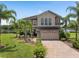 Charming two-story home with a manicured lawn, brick driveway, and stone accents at 15037 Cedar Branch Way, Orlando, FL 32824
