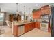 Open kitchen featuring wood cabinets, granite countertops, and stainless steel appliances at 15037 Cedar Branch Way, Orlando, FL 32824