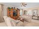 Inviting living room featuring a large entertainment center, ceiling fan, and comfortable neutral-toned seating at 15037 Cedar Branch Way, Orlando, FL 32824