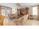 Comfortable living room with a large entertainment center, plush sofas, and access to the backyard at 15037 Cedar Branch Way, Orlando, FL 32824