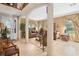 Open-concept living room with a decorative entry door, plush sofas, and neutral finishes at 15037 Cedar Branch Way, Orlando, FL 32824