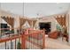 Cozy loft space with comfortable seating, a desk area, large windows with decorative curtains, and a ceiling fan at 15037 Cedar Branch Way, Orlando, FL 32824