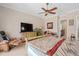 Spacious primary bedroom with upholstered chair, neutral walls, and carpet floors at 15037 Cedar Branch Way, Orlando, FL 32824