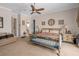 Spacious primary bedroom with neutral walls, upholstered chair, and carpet flooring at 15037 Cedar Branch Way, Orlando, FL 32824