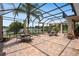 Large screened-in patio with brick flooring offering beautiful lake views at 15037 Cedar Branch Way, Orlando, FL 32824