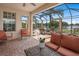 Outdoor patio with comfortable seating and views of the lake at 15037 Cedar Branch Way, Orlando, FL 32824