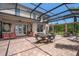 The brick patio has a screened enclosure and dining and lounging areas at 15037 Cedar Branch Way, Orlando, FL 32824