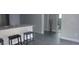 Open kitchen with bar seating, seamlessly flowing into adjacent spaces with modern finishes at 1605 N Orange St, Mount Dora, FL 32757
