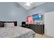 Comfortable bedroom with bed, desk, dresser and TV. The room features blue walls and a ceiling fan at 1651 Windsor Oak Ct, Kissimmee, FL 34744