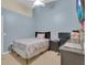 Cozy bedroom with blue walls, neutral carpet, ceiling fan, and comfortable furniture including a bed and desk at 1651 Windsor Oak Ct, Kissimmee, FL 34744