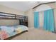 Bedroom featuring a bunk bed, carpet flooring, and sheer curtains at 1651 Windsor Oak Ct, Kissimmee, FL 34744