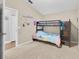 Bedroom featuring carpet flooring, a bunk bed, and easy access to an adjacent room at 1651 Windsor Oak Ct, Kissimmee, FL 34744