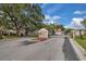 Community entrance to Windsor Oaks with gate and sign, surrounded by mature trees at 1651 Windsor Oak Ct, Kissimmee, FL 34744