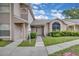 Charming townhome featuring a well-manicured lawn and inviting front entrance at 1651 Windsor Oak Ct, Kissimmee, FL 34744