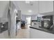 Well-lit kitchen featuring stainless steel appliances and views of the adjacent dining area at 1651 Windsor Oak Ct, Kissimmee, FL 34744